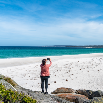 person taking photo of the beach